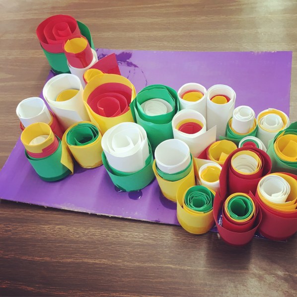 Students create abstract sculptures using paper and art paste.