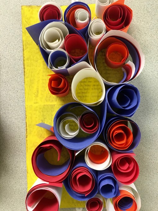 Students create abstract sculptures using paper and art paste.